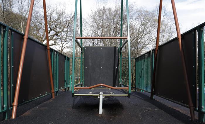 Green and orange wheelchair accessible swing